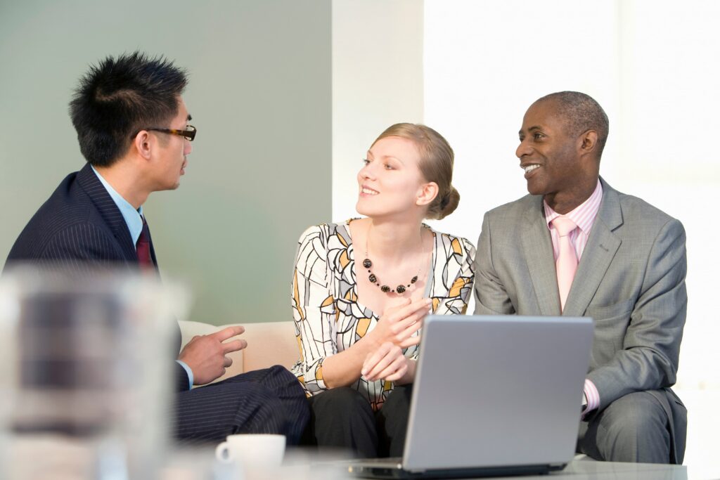 3 people sitting down together in a consultation meeting